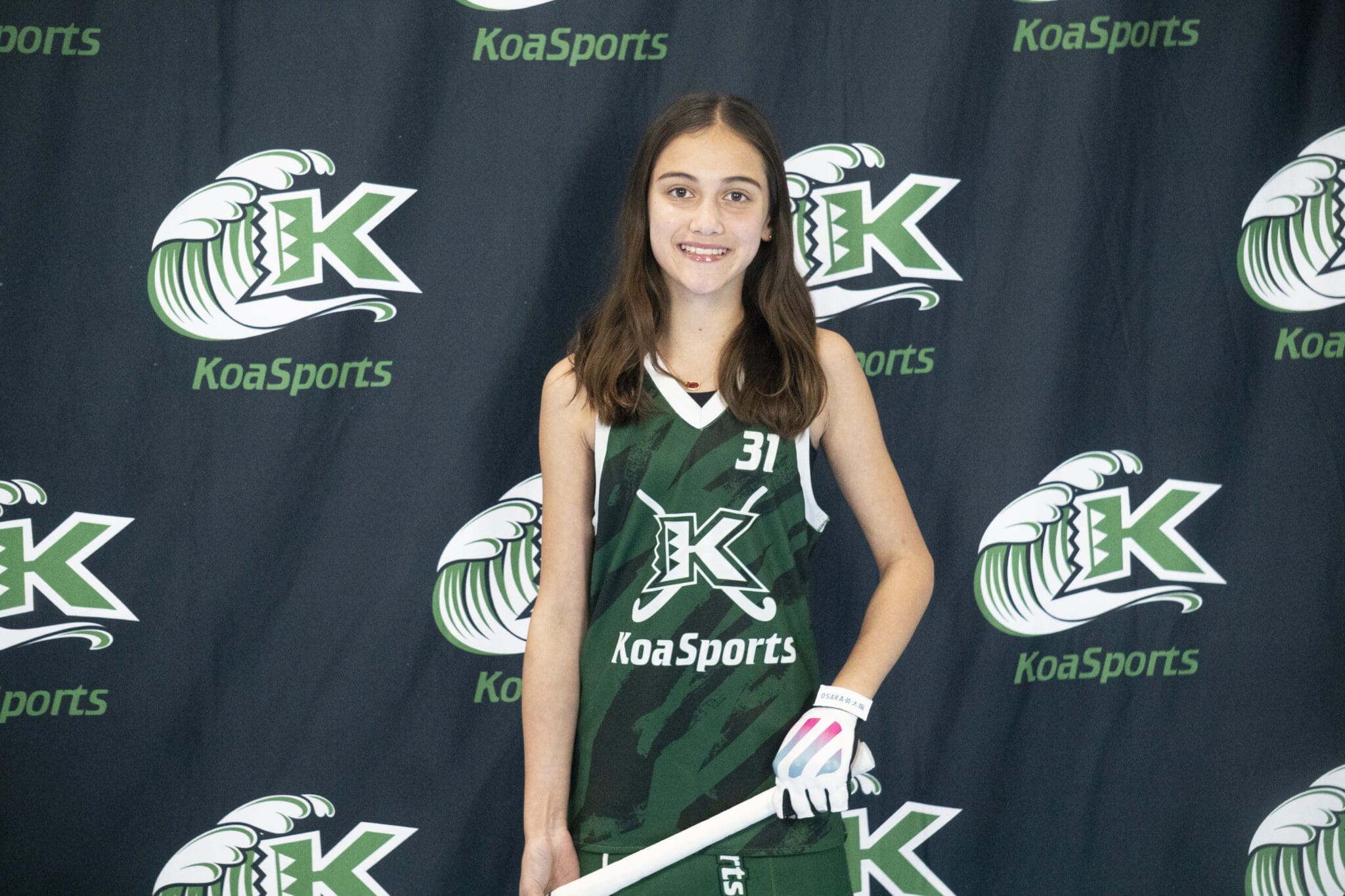 Teen softball player wearing number 31 jersey